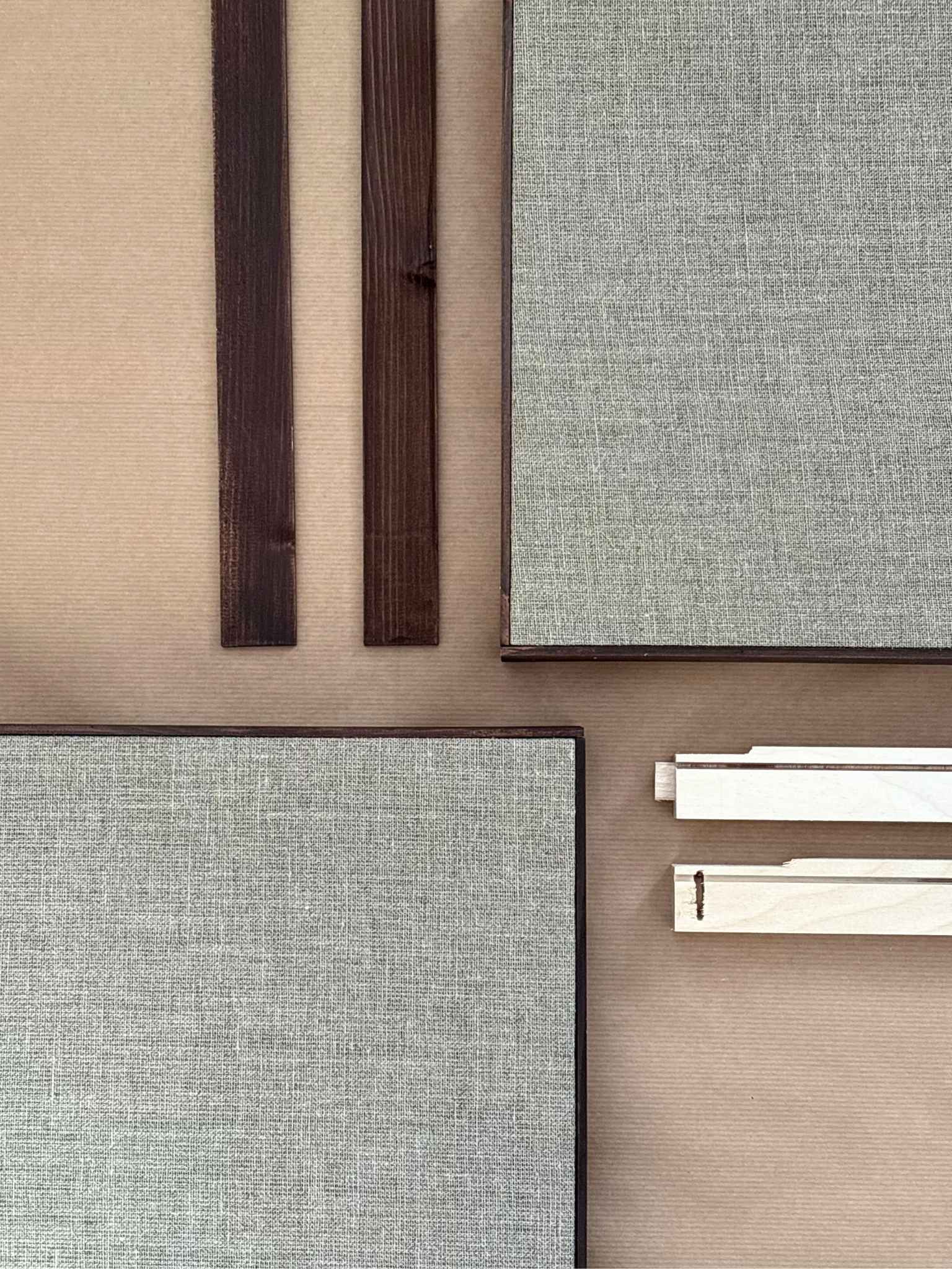 Detailed flat lay of framed linen canvases and handcrafted wooden frame components, showing everything included to create your own framed artwork at home with a DIY linen canvas art kit.