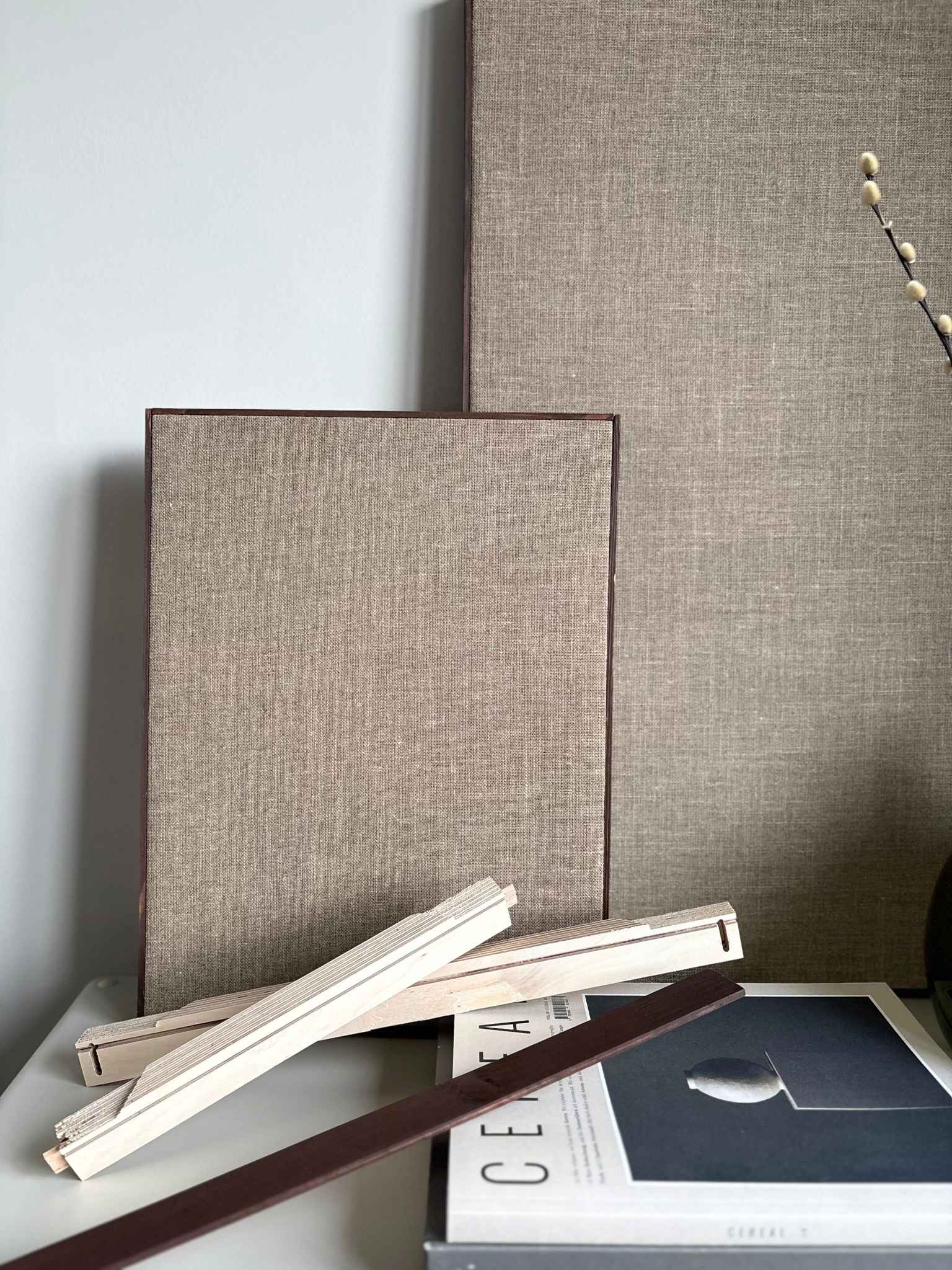 Framed linen canvas artworks displayed in two sizes, showing the finished result from a DIY framed linen canvas art kit with handcrafted wooden edge frames