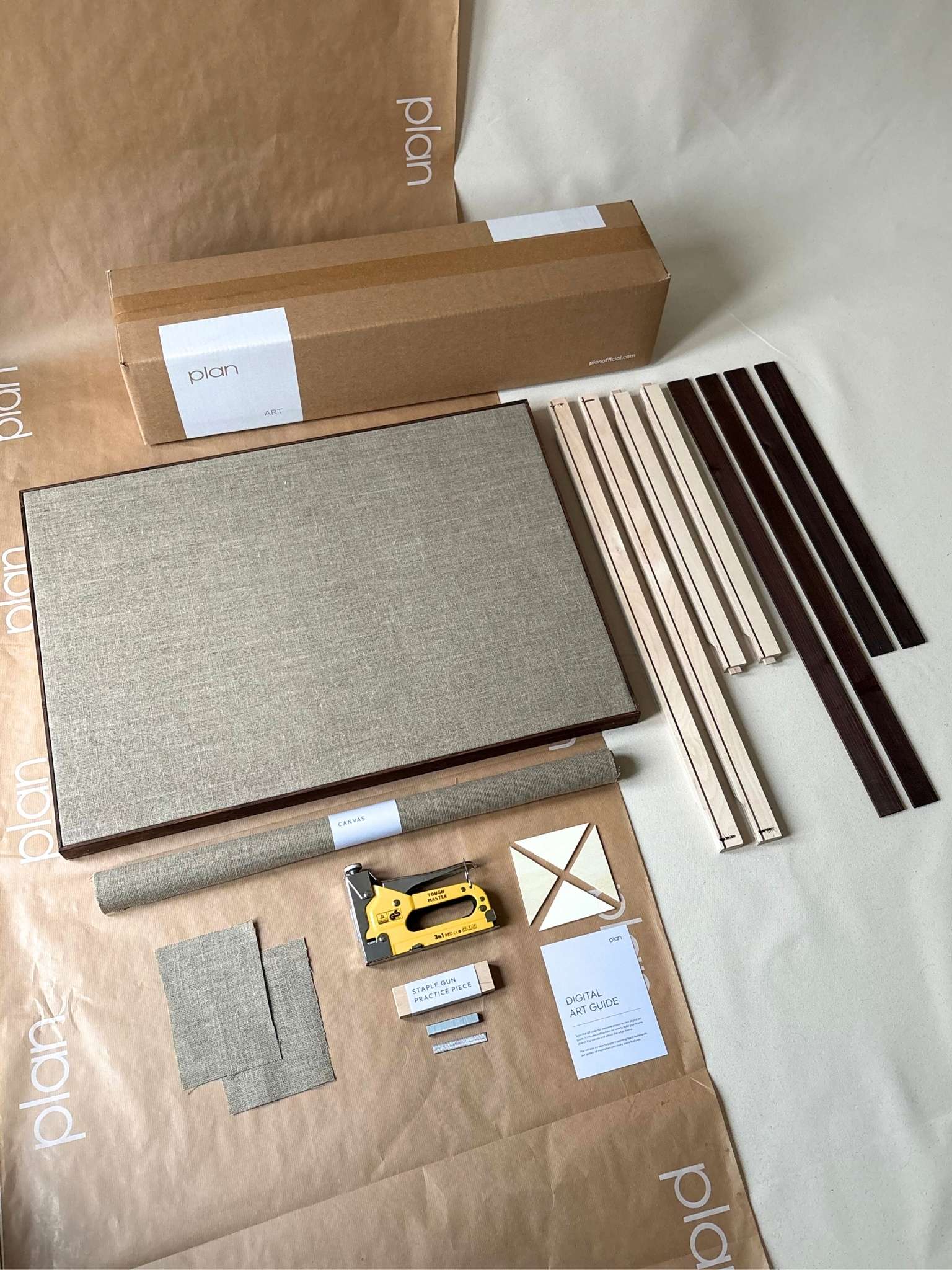Large framed linen canvas kit with dark oak edge frame, showing pre-assembled inner frame, rolled linen canvas and dark oak edge frame pieces, designed for creating a DIY framed canvas base at home.