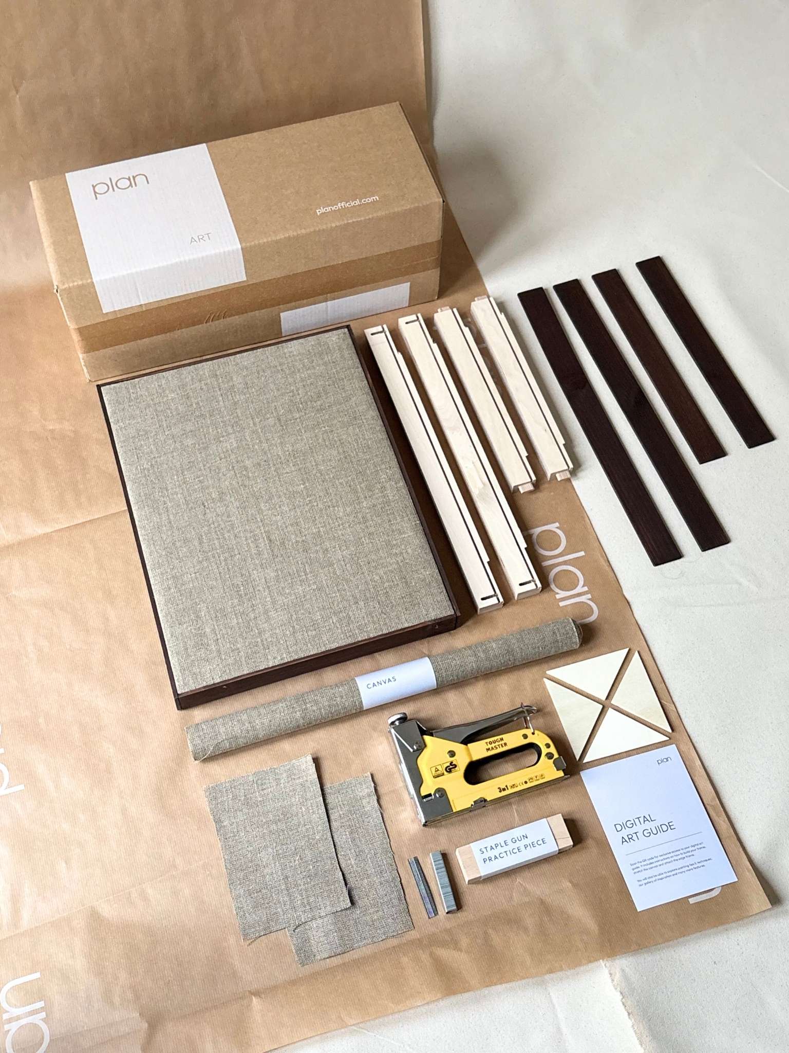 Small framed linen canvas kit with dark oak edge frame, showing custom inner frame, rolled linen canvas and dark oak edge frame pieces for building and stretching a framed canvas at home.