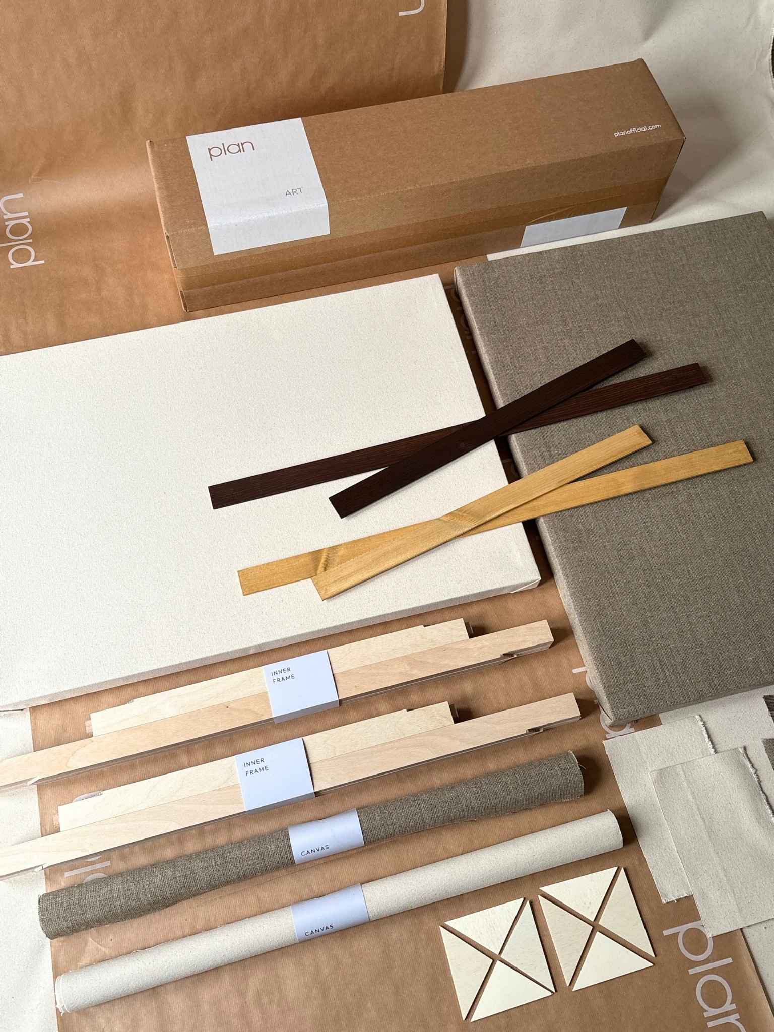 Large double mixed canvas framed art kit by Plan, including one oak and one dark oak edge frame, blank cotton and linen canvases, handcrafted inner frames, staple gun and all components displayed together.