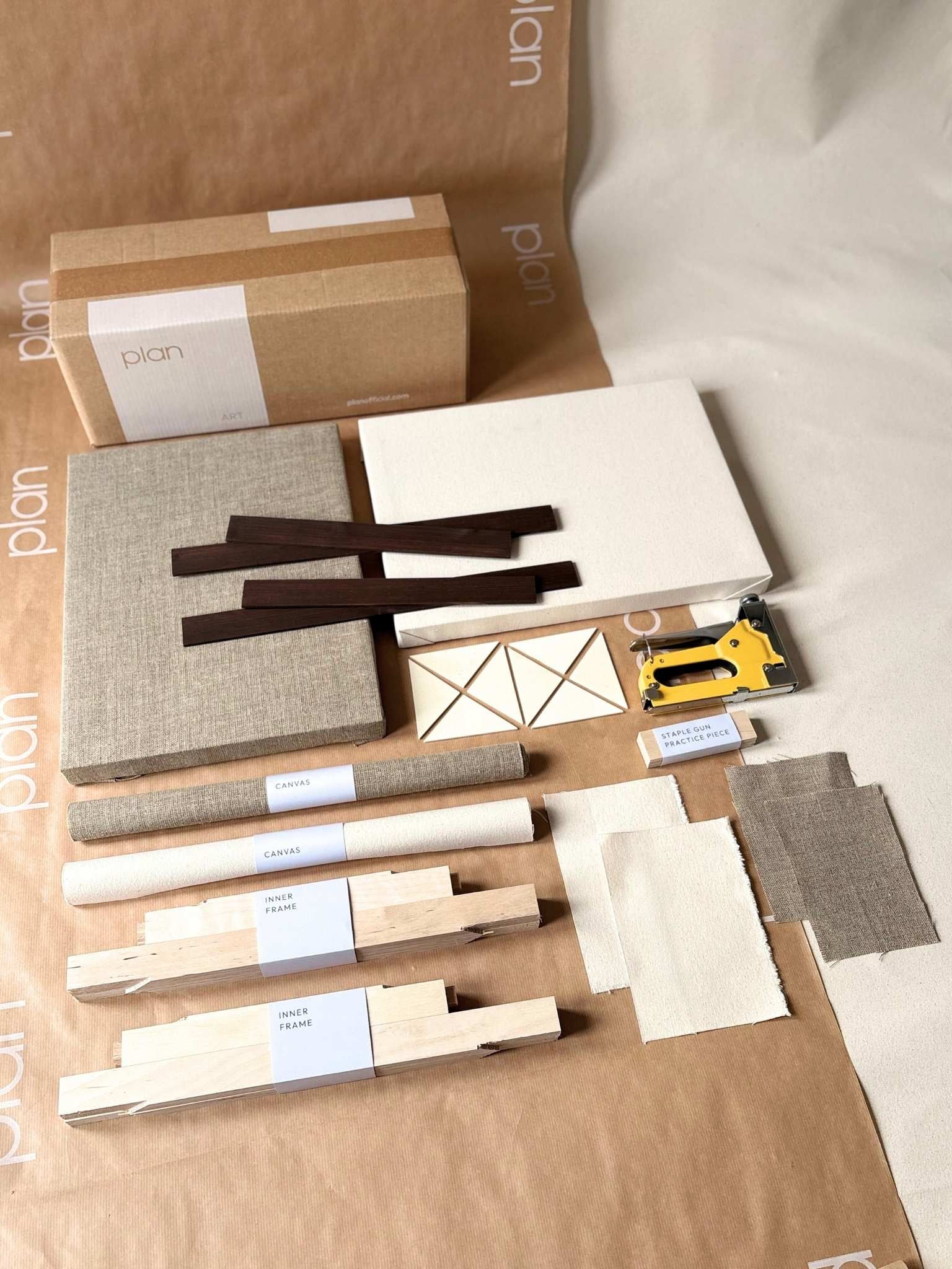 Small double DIY framed canvas art kit by Plan with dark oak edge frame, showing blank cotton and linen canvases, inner frame parts, staple gun, practice pieces and complete kit contents.